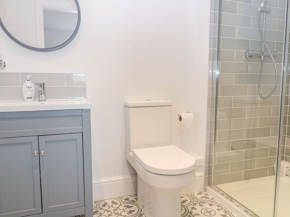 A bathroom with a sink and a shower enclosure at The Croft in Ashbourne