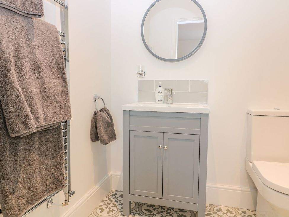 A bathroom with a sink and towel rack at The Croft in Ashbourne