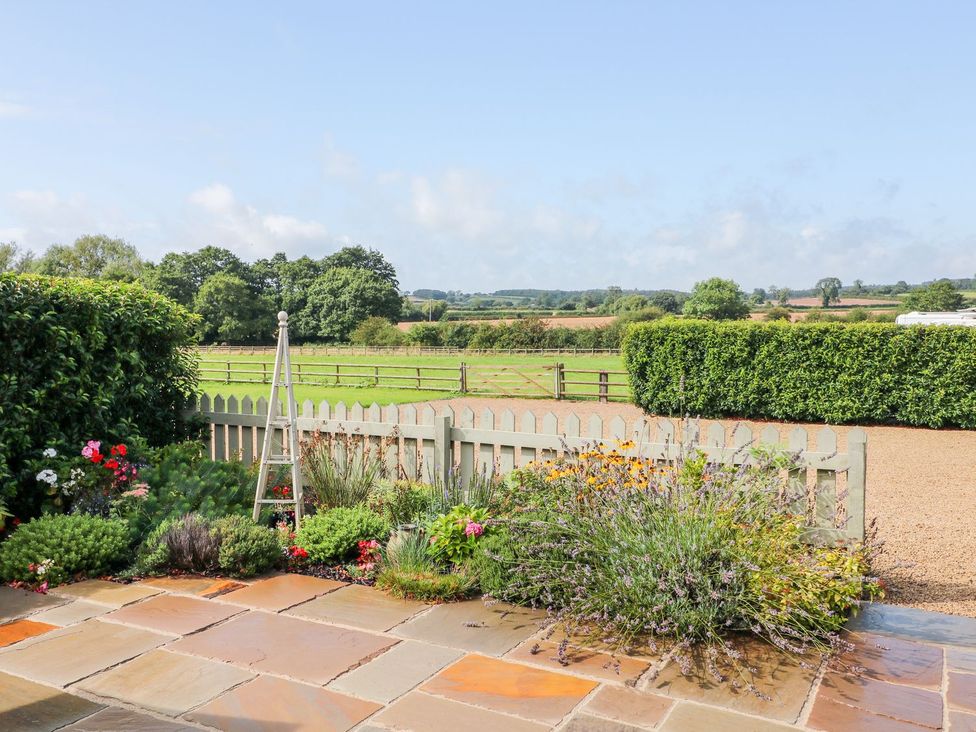 An outdoor area with a fence and flowers at The Croft in Ashbourne