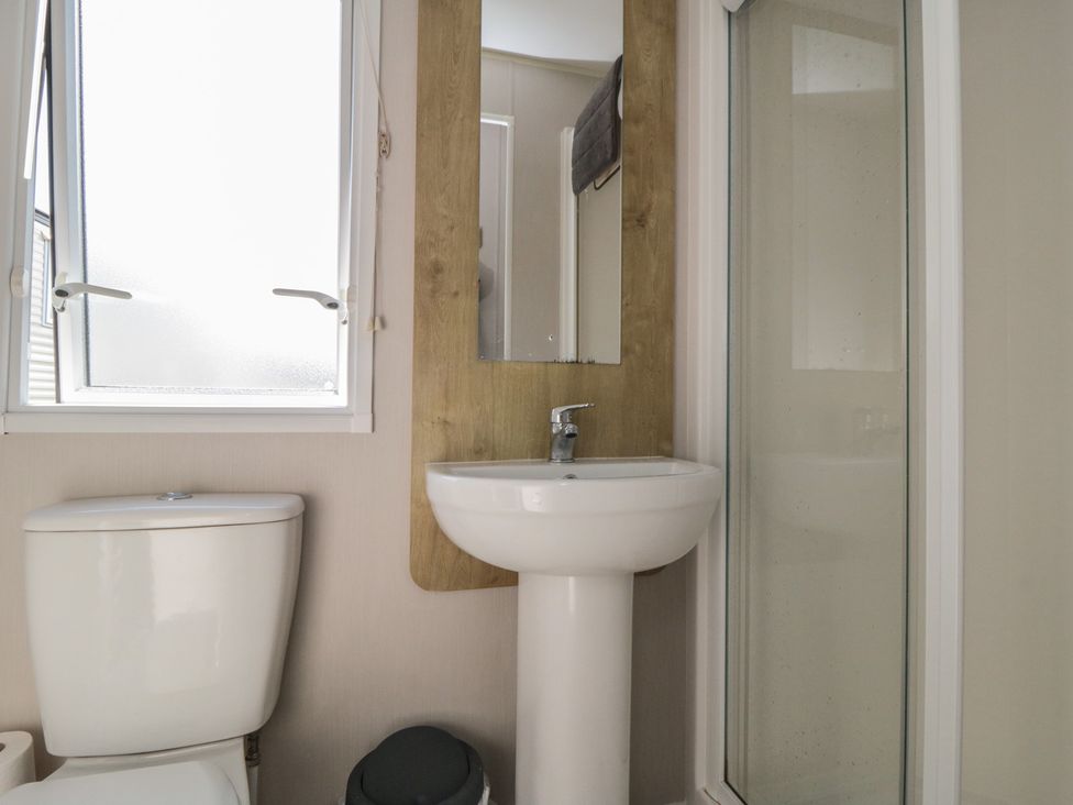 A bathroom with a sink, toilet, and shower at 10 Gosling in Scarborough
