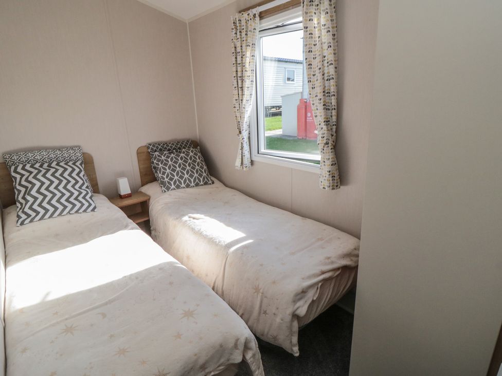A bedroom with two single beds and a window at 10 Gosling in Scarborough