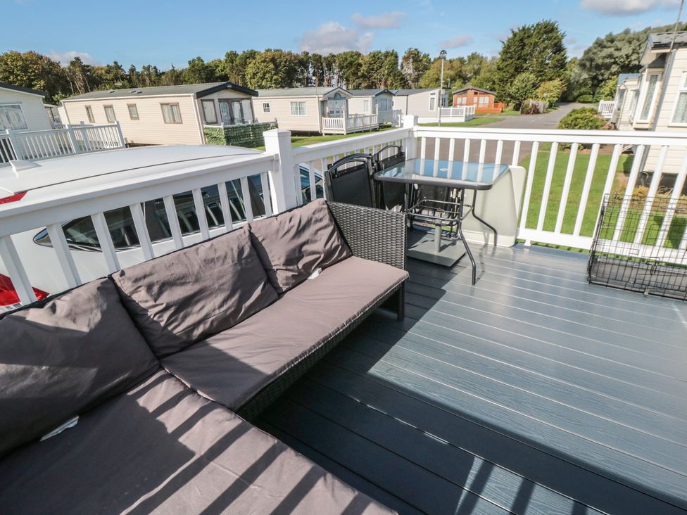 A deck with a sofa and table at 10 Gosling in Scarborough