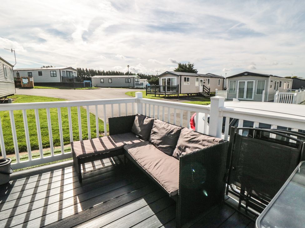 An outdoor seating area with a sofa and table at 10 Gosling in Scarborough