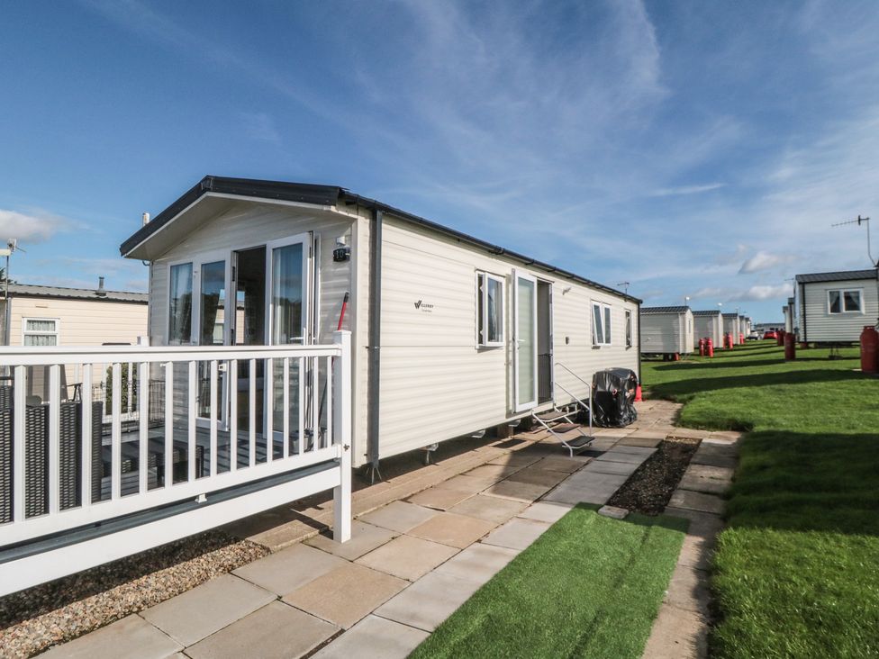 A mobile home with a deck and lawn at 10 Gosling, Scarborough