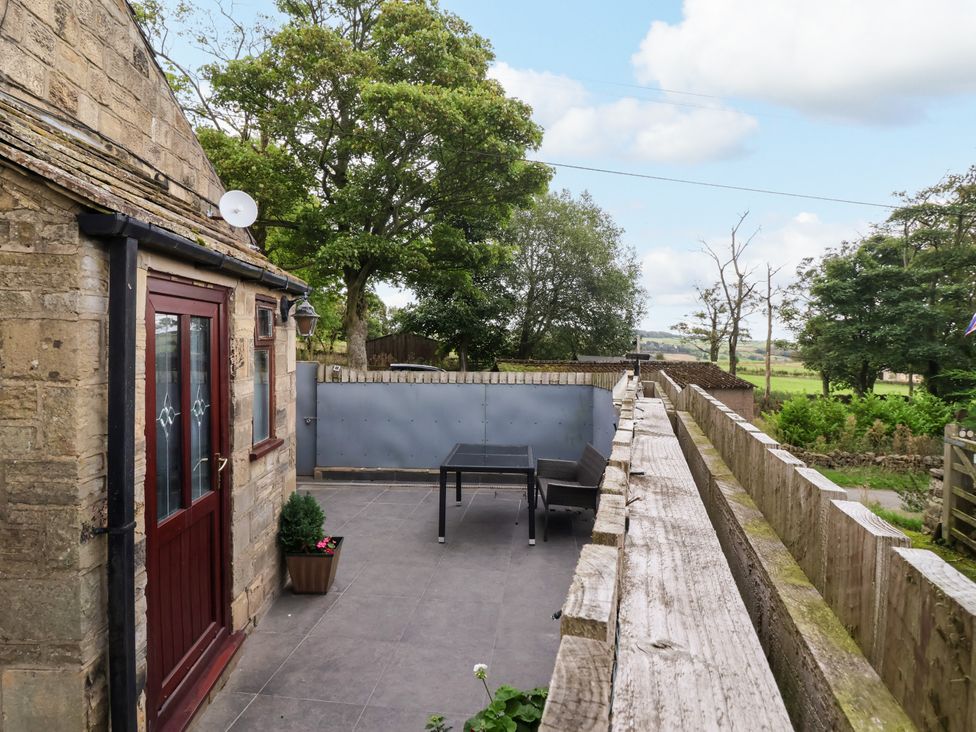 An outdoor area with a table and chairs at Brownhill Bungalow West Morton near Riddlesden