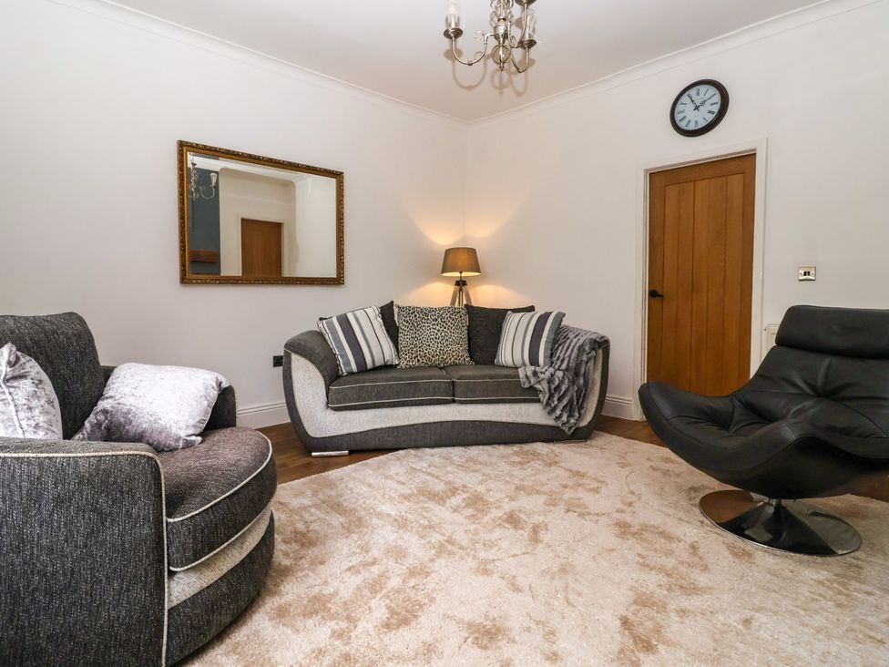 A living room with a sofa and armchair at Brownhill Bungalow in West Morton near Riddlesden