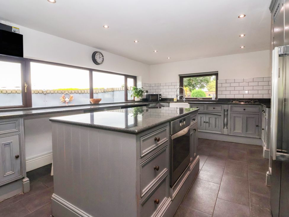 A kitchen with an island and modern appliances at Brownhill Bungalow West Morton near Riddlesden