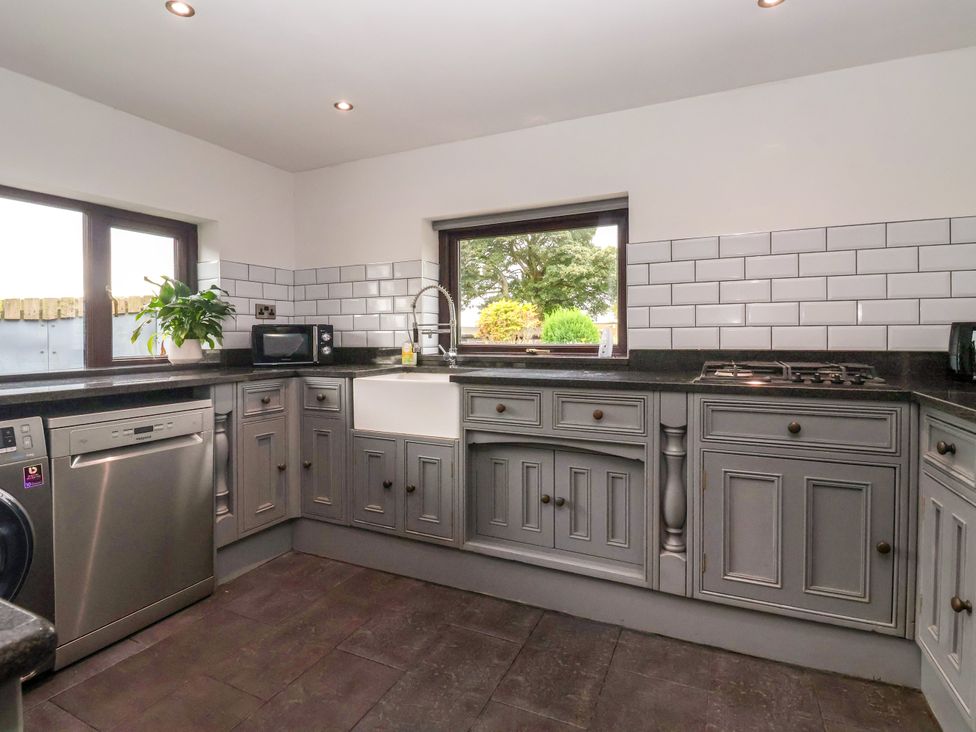 A kitchen with cabinets and appliances at Brownhill Bungalow in West Morton near Riddlesden