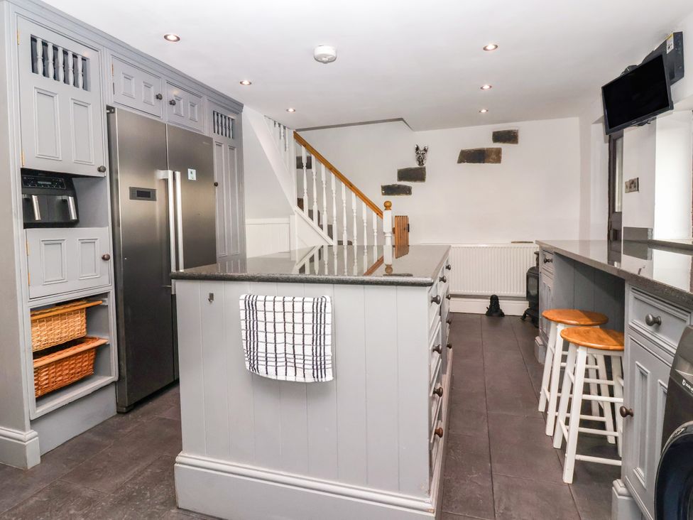 A kitchen with a refrigerator and countertop at Brownhill Bungalow in West Morton near Riddlesden