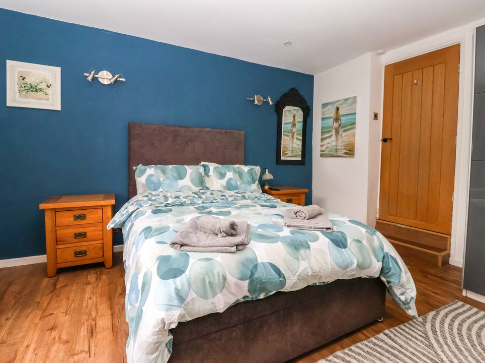 A bedroom with bed and bedside table at Brownhill Bungalow West Morton near Riddlesden