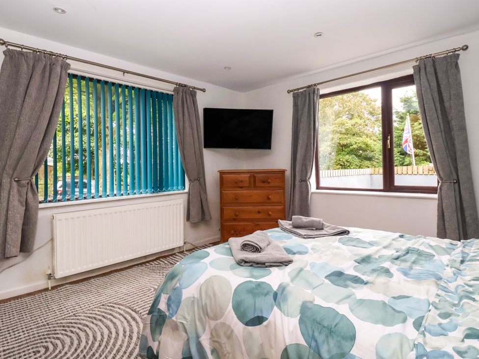 A bedroom with a bed and dresser at Brownhill Bungalow West Morton near Riddlesden