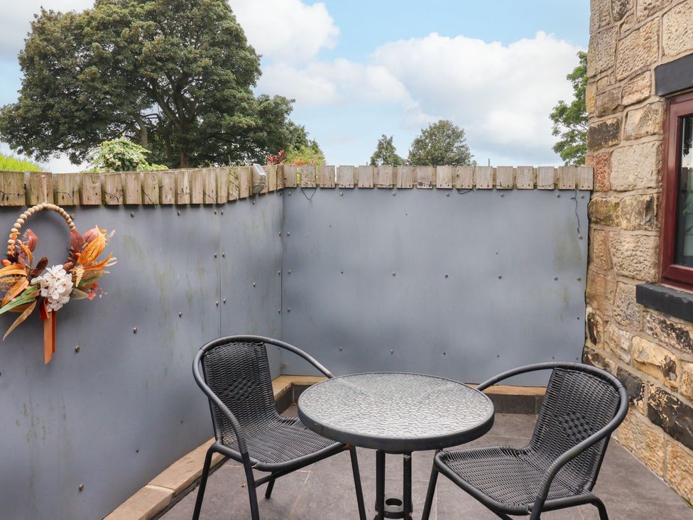 An outdoor space with a table and chairs at Brownhill Bungalow West Morton near Riddlesden