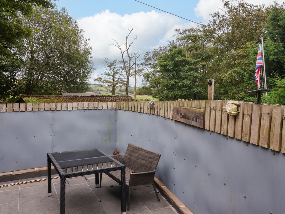 An outdoor seating area with a table and chair at Brownhill Bungalow near West Morton