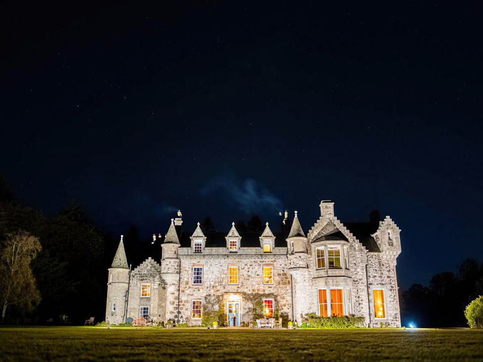 A castle illuminated at night at Wardhill Castle near Inverurie