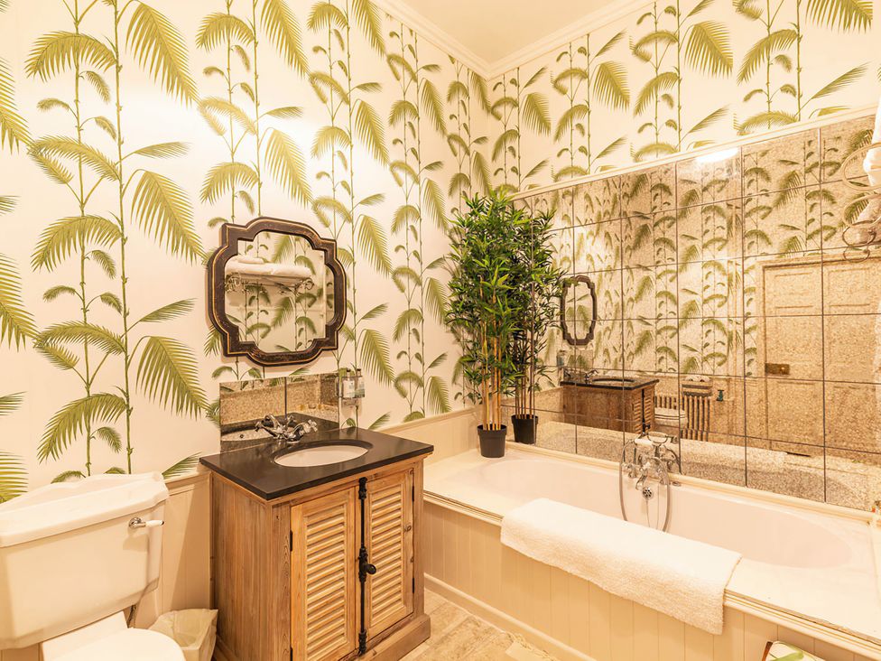 A bathroom with a bathtub and vanity at Wardhill Castle near Inverurie
