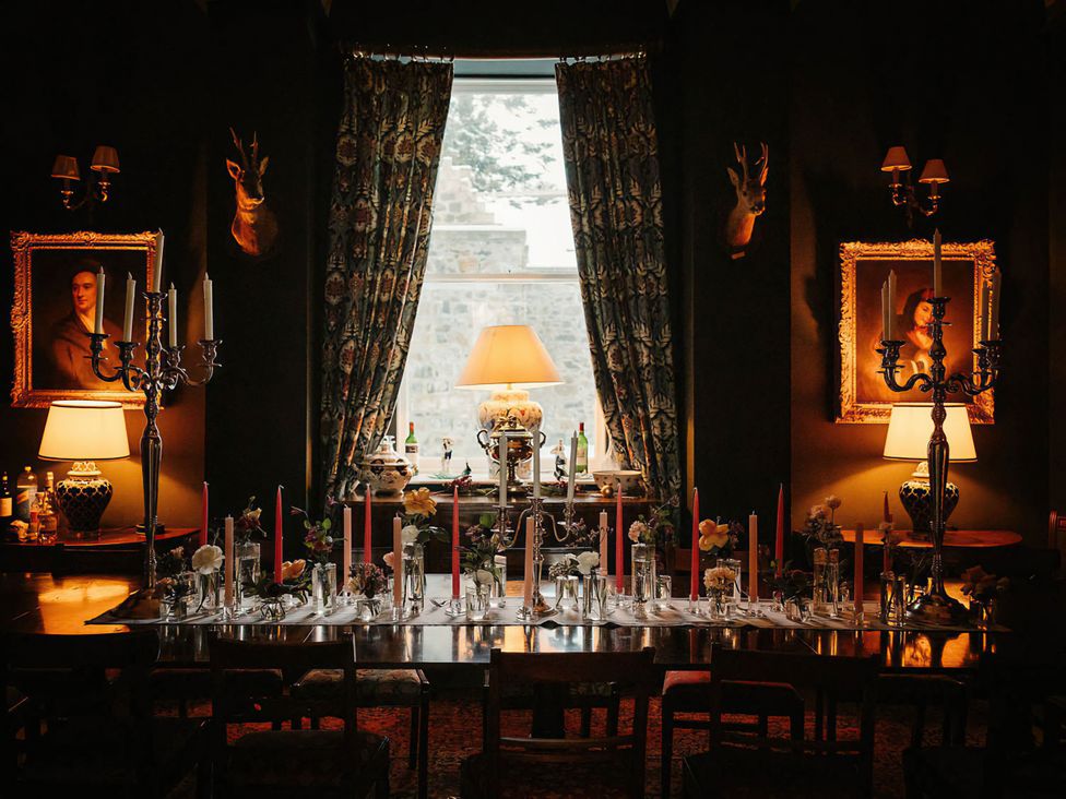 A dining room with a table set for a meal at Wardhill Castle near Inverurie