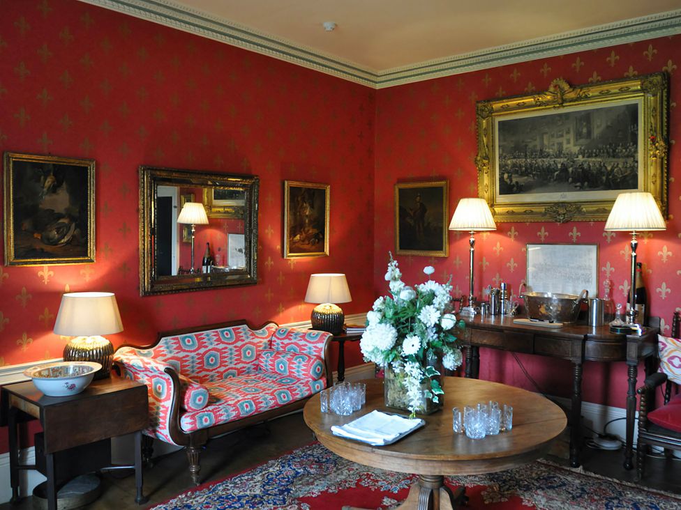 A sitting room with a sofa and a table at Wardhill Castle near Inverurie