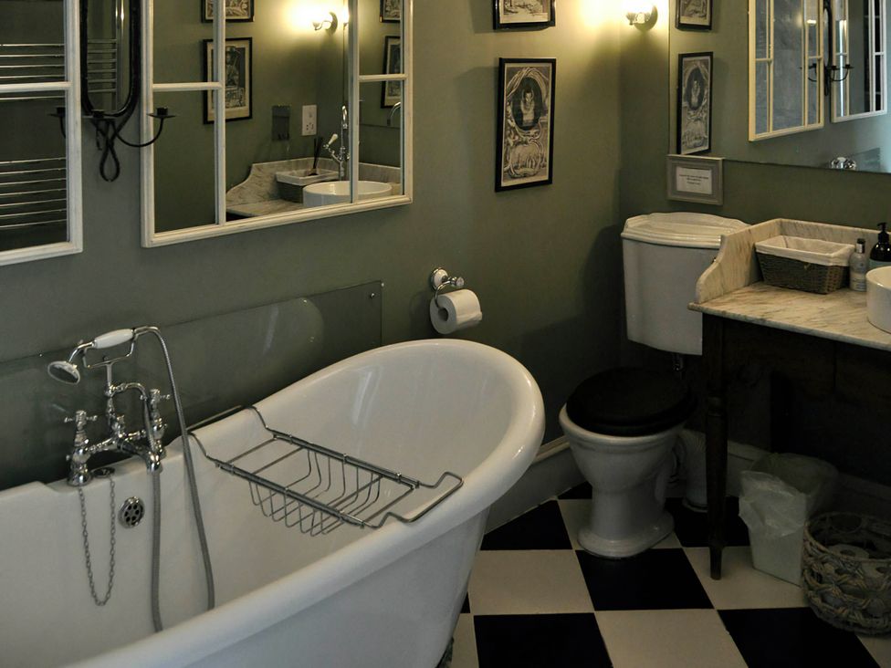 A bathroom with a bathtub, toilet, and sink at Wardhill Castle near Inverurie