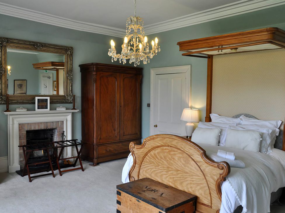 A bedroom with a bed and wardrobe at Wardhill Castle near Inverurie