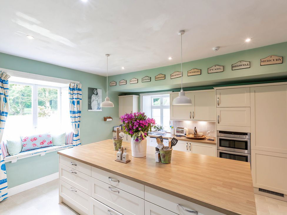 A kitchen with an island and window at Wardhill Castle near Inverurie