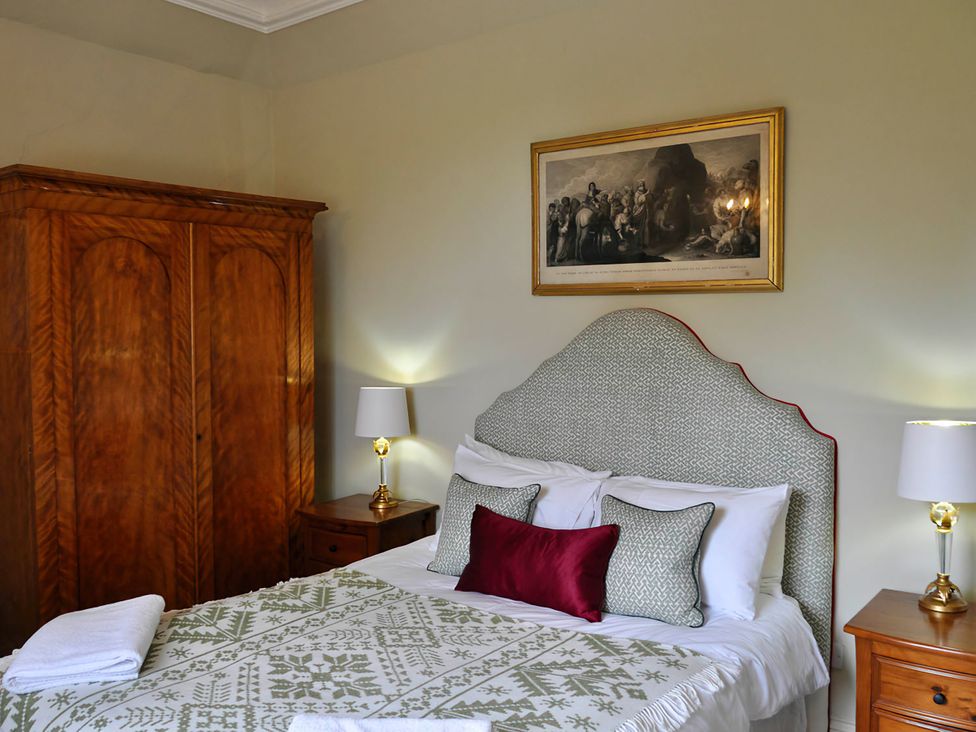 A bedroom with a bed and wardrobe at Wardhill Castle near Inverurie
