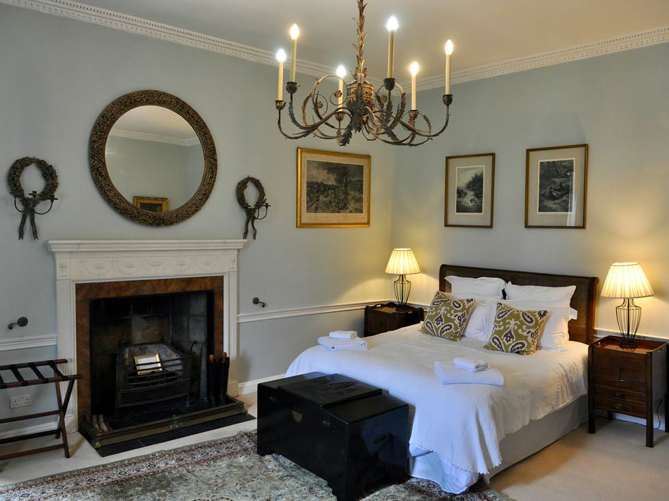 A bedroom with a bed and fireplace at Wardhill Castle near Inverurie