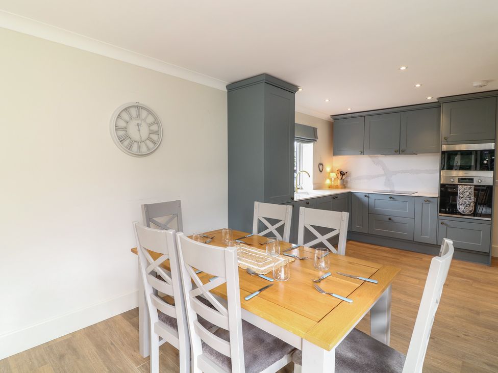 A dining room with a table and chairs at The Willows in Mablethorpe