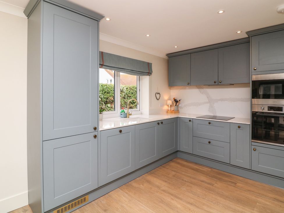 A kitchen with cabinets and appliances at The Willows in Mablethorpe