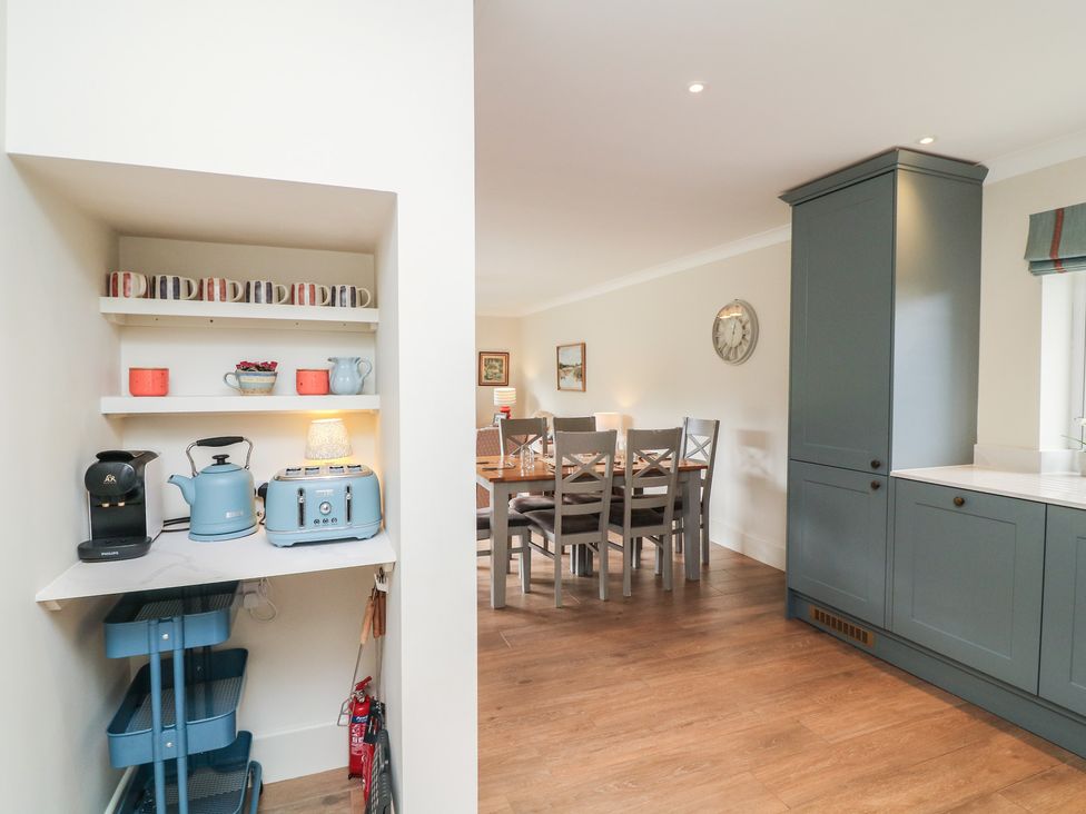 A kitchen with a countertop and dining area at The Willows in Mablethorpe