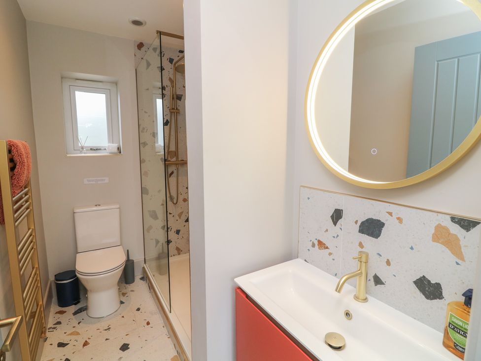A bathroom with a shower and sink at The Willows in Mablethorpe