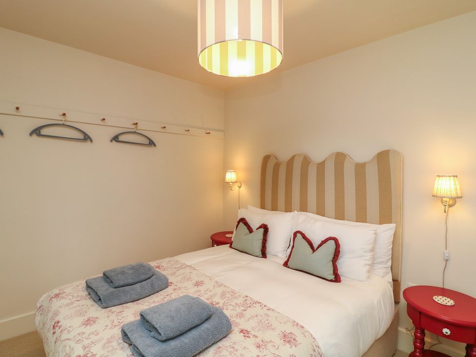 A bedroom with a bed and side tables at The Willows in Mablethorpe