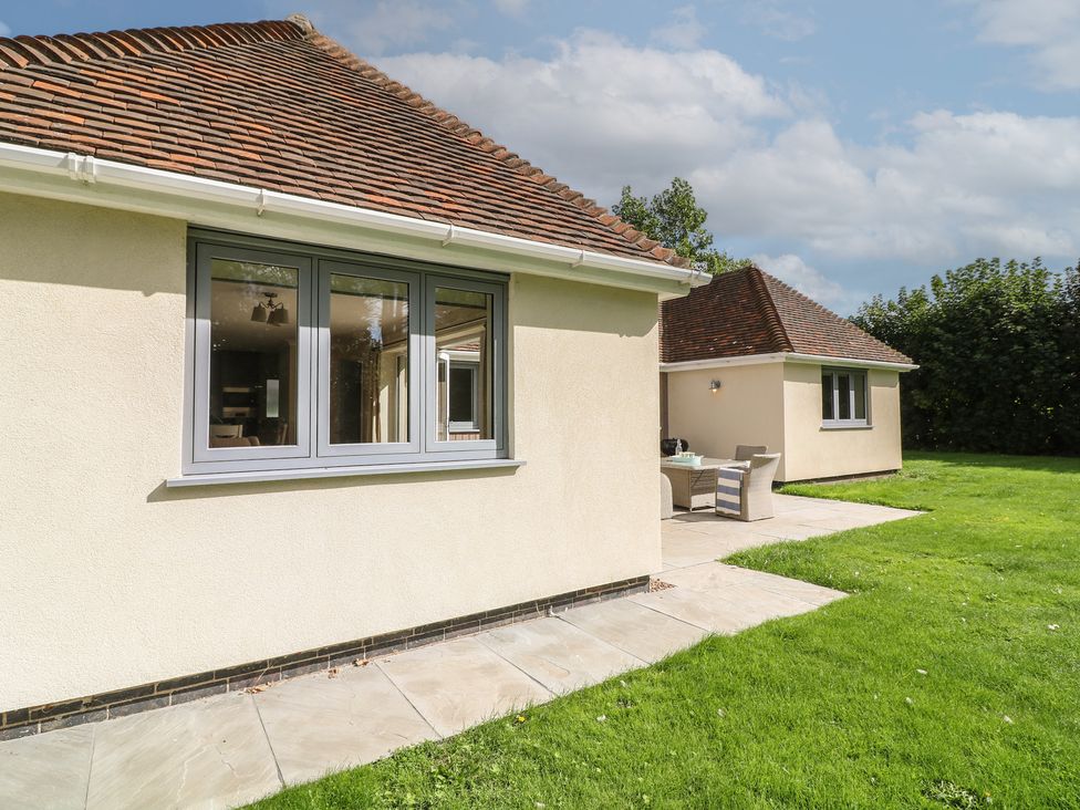 A house exterior with a patio and garden at The Willows in Mablethorpe