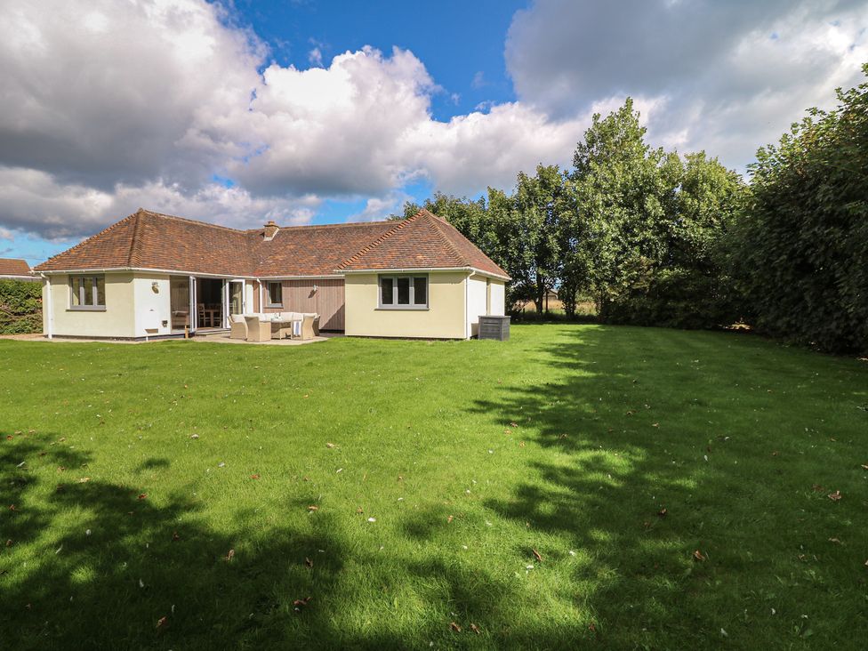 A house with a lawn and trees at The Willows in Mablethorpe