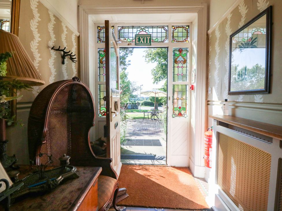An entrance hall with a door leading outside at Meifod Country House Caernarfon