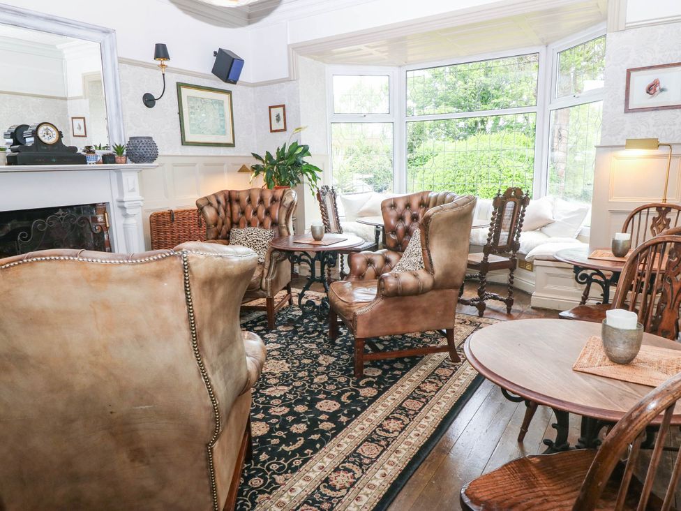 A snug with seating and a coffee table at Meifod Country House in Caernarfon