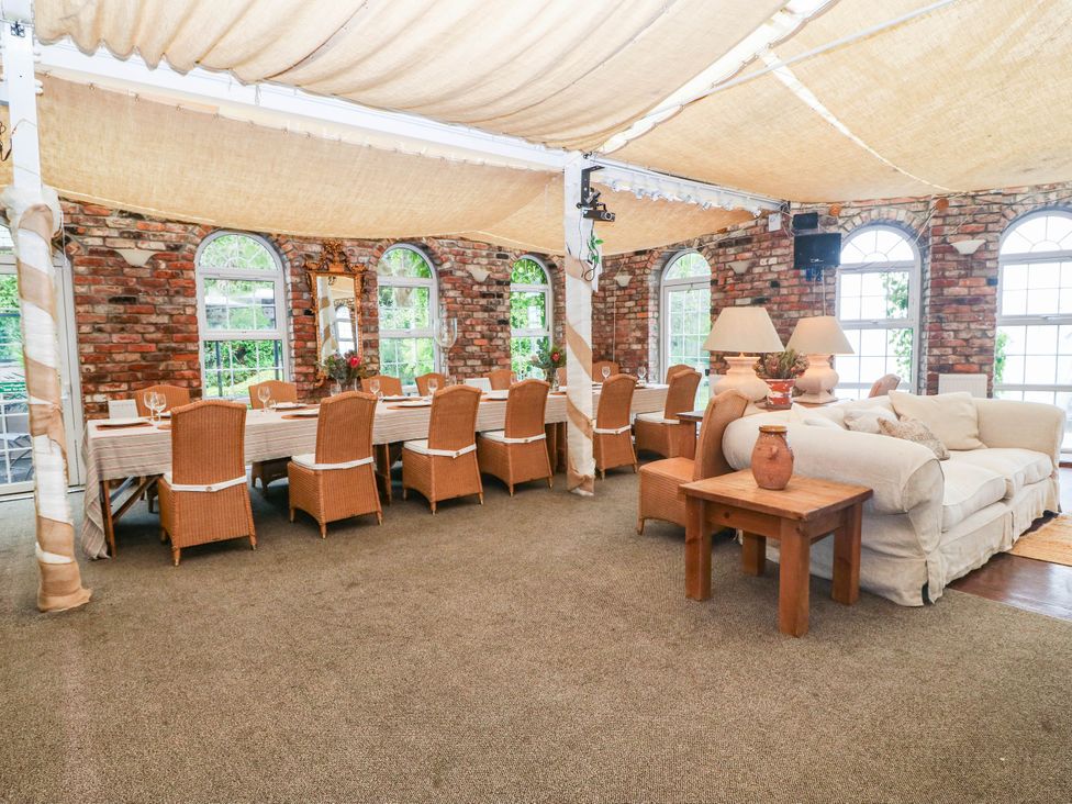 A dining room with a large table and chairs at Meifod Country House Caernarfon