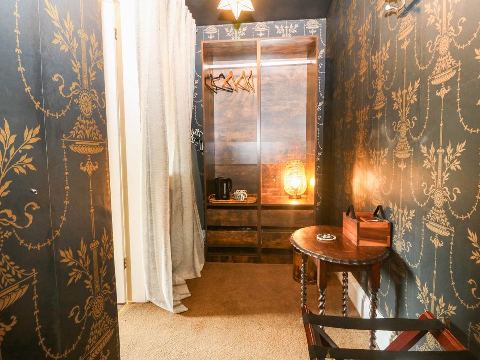 A closet with shelves and a table at Meifod Country House Caernarfon