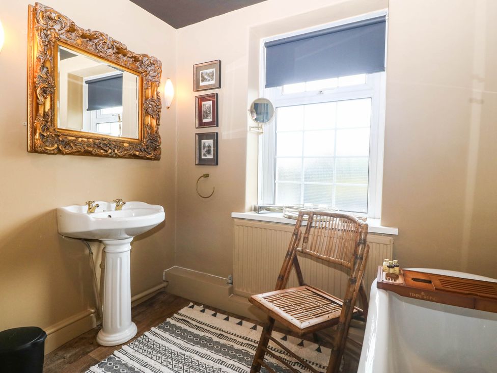 A bathroom with a washbasin and a bathtub at Meifod Country House Caernarfon