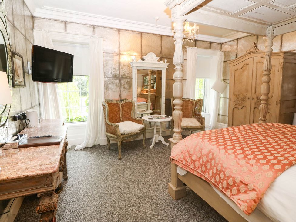 A bedroom with a bed and television at Meifod Country House in Caernarfon
