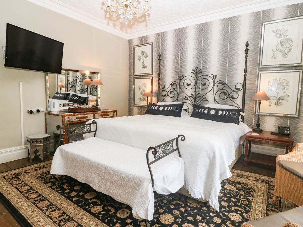 A bedroom with a double bed and television at Meifod Country House in Caernarfon