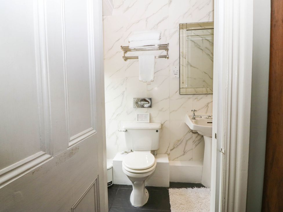 A bathroom with a toilet and sink at Meifod Country House, Caernarfon