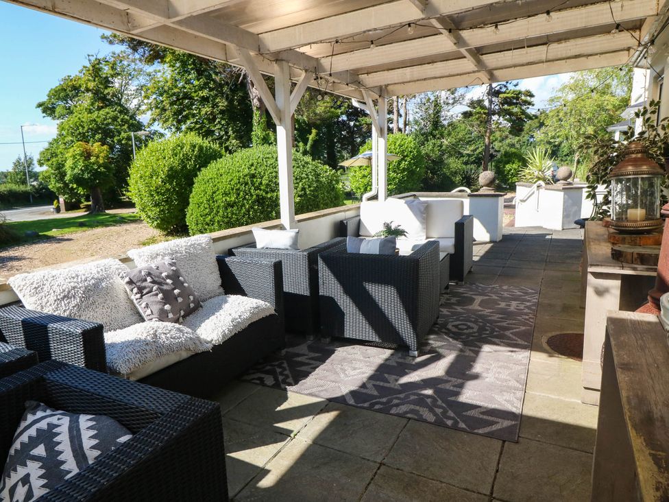 An outdoor seating area with sofas and chairs at Meifod Country House Caernarfon