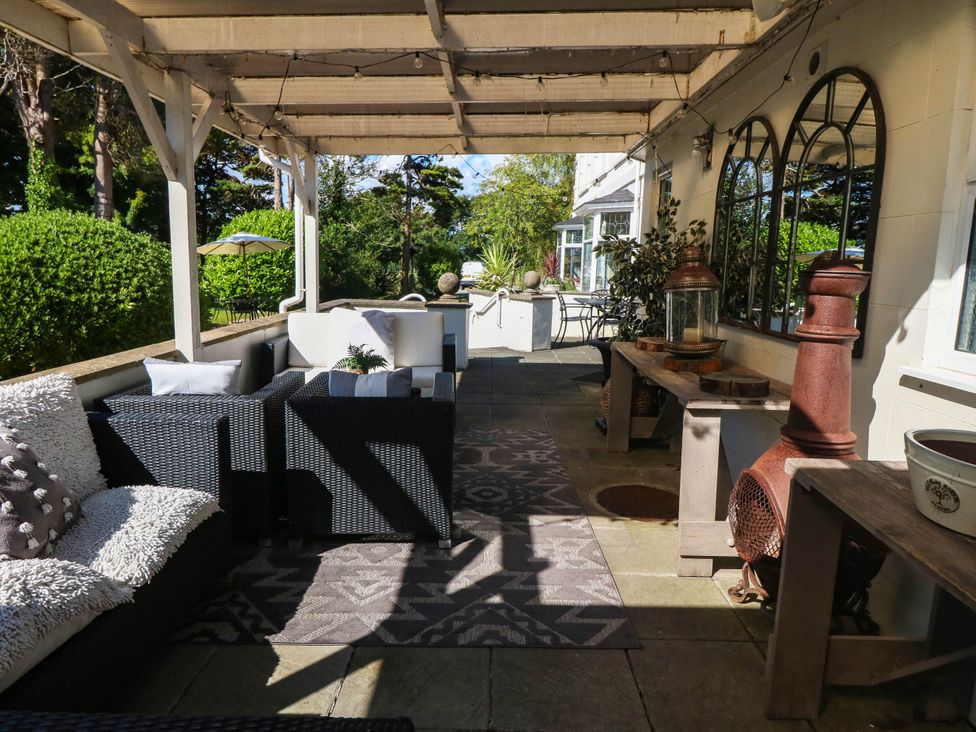An outdoor patio with seating and decorative items at Meifod Country House in Caernarfon