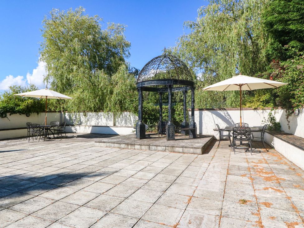 An outdoor area with a gazebo and seating at Meifod Country House in Caernarfon
