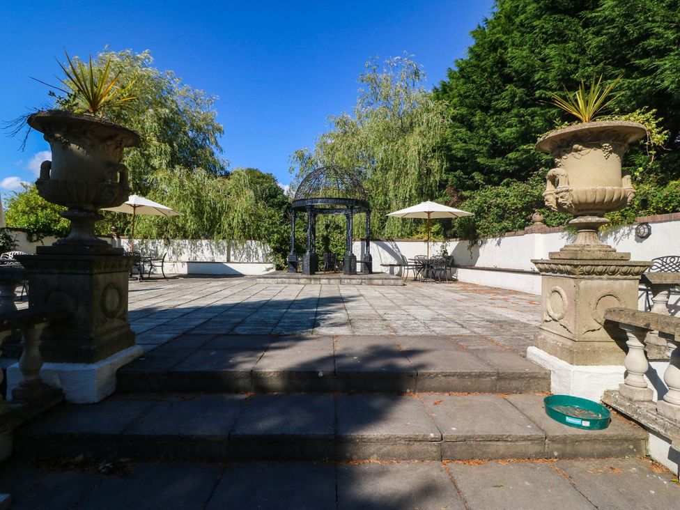 An outdoor area with a gazebo and seating at Meifod Country House in Caernarfon