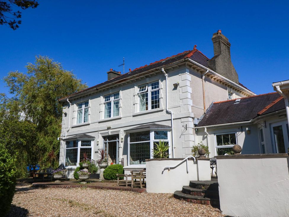 An exterior view of a house with plants and windows at Meifod Country House in Caernarfon