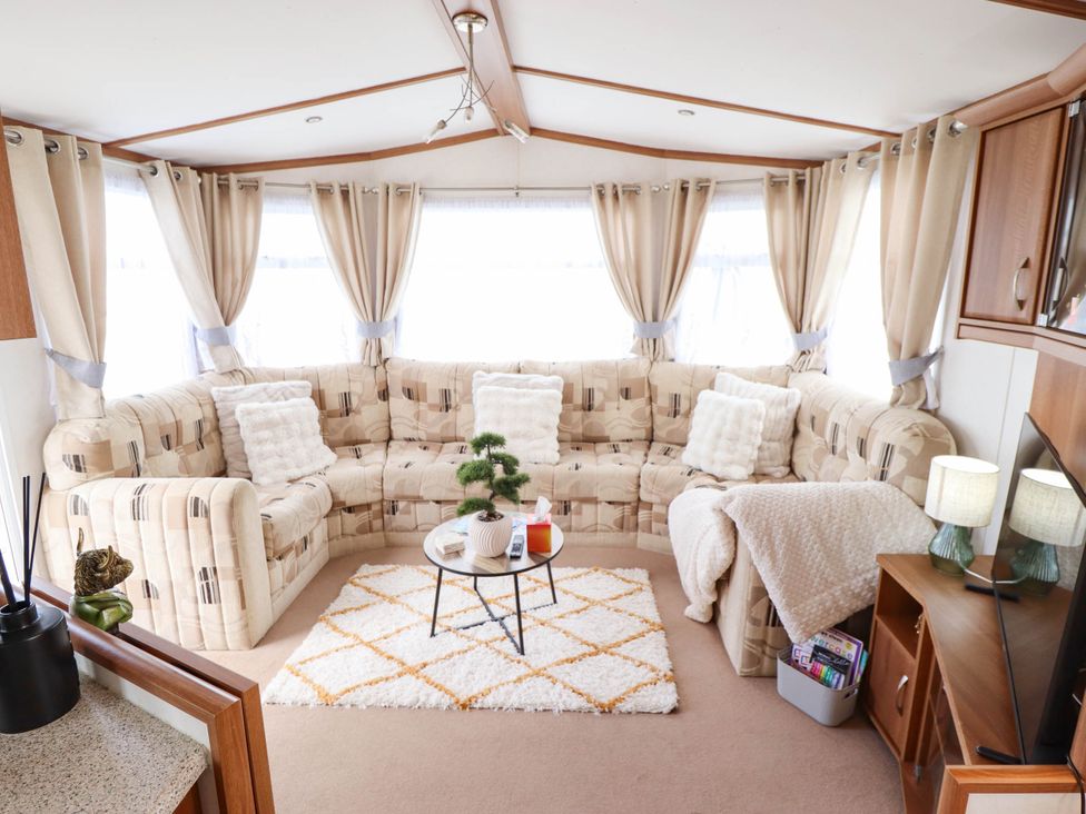 A living room with a corner sofa and coffee table at Atlas in Ingoldmells