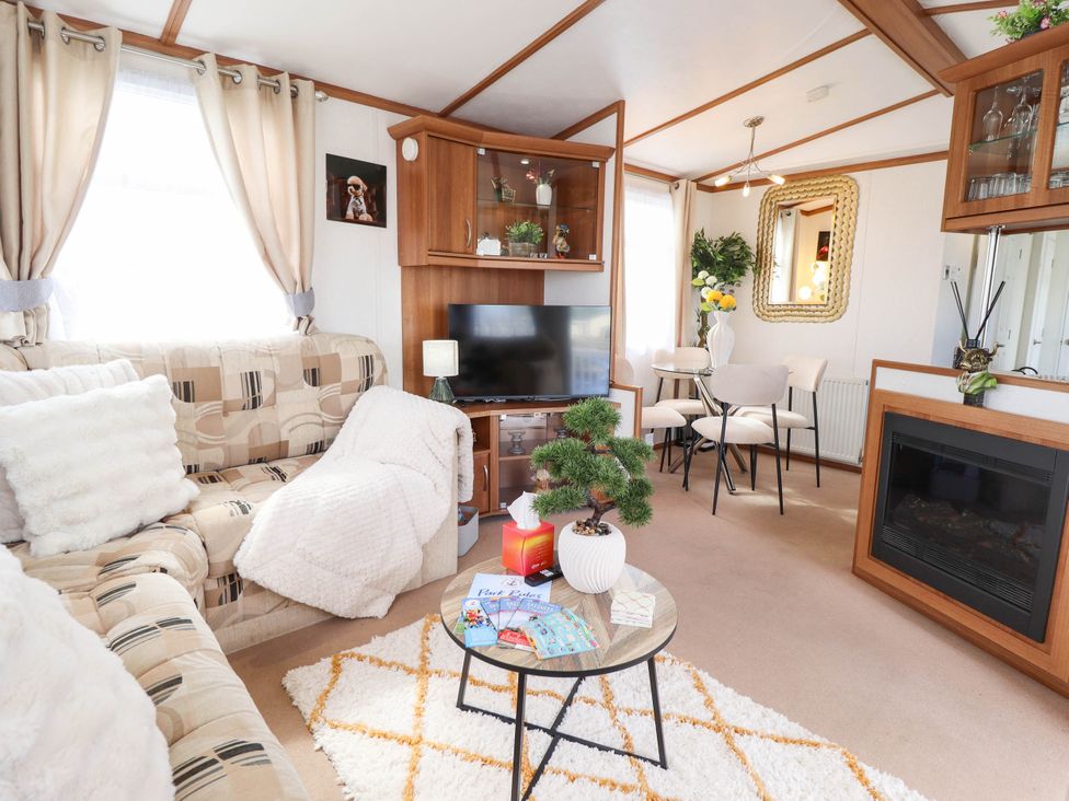 A living room with a television and coffee table at Atlas in Ingoldmells