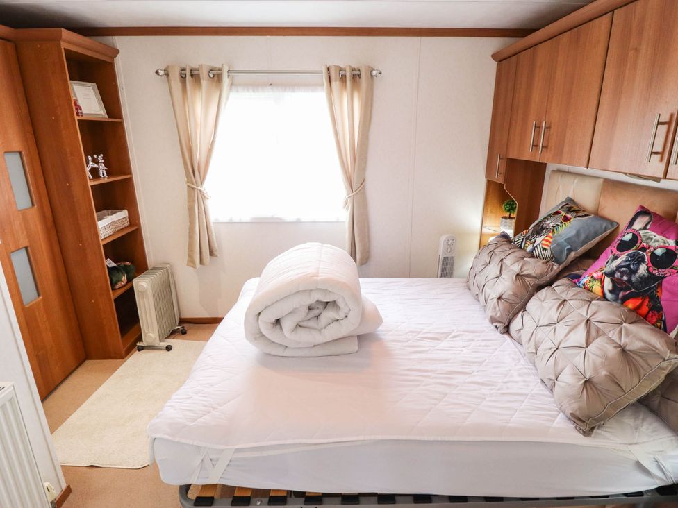 A bedroom with a bed and shelf at Atlas in Ingoldmells