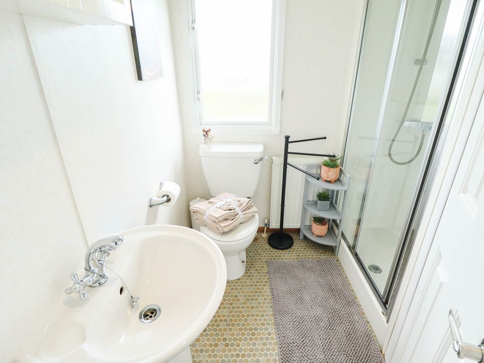 A bathroom with a sink and toilet at Atlas in Ingoldmells